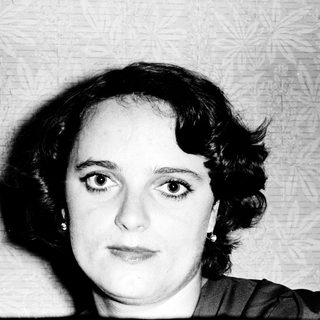 Black-and-white portrait of a woman with short hair.