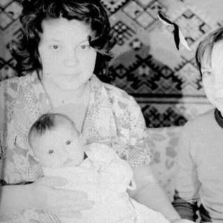 Family portrait with mother, baby, and older child.