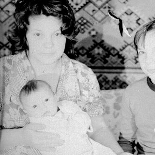Family portrait with mother, baby, and older child.