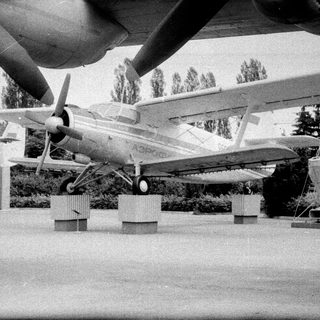 Vintage propeller aircraft on display outdoors.