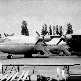 Four-engine propeller transport aircraft with missiles.