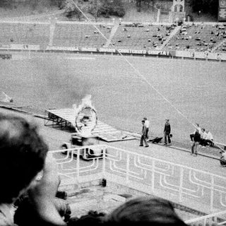 Olympic torch lighting ceremony in stadium.