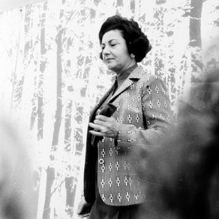 Woman speaking at an indoor event.