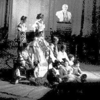 Stage performance celebrating 50th anniversary with classical attire.