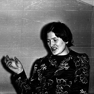 Person singing or speaking on stage.