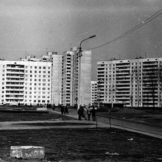Mid-century Soviet-era apartment blocks with bare trees.
