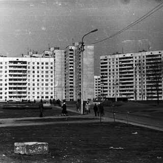 Soviet-era high-rise apartment blocks in urban area.