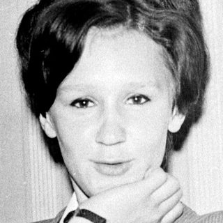 Black-and-white portrait of a woman in a blazer.