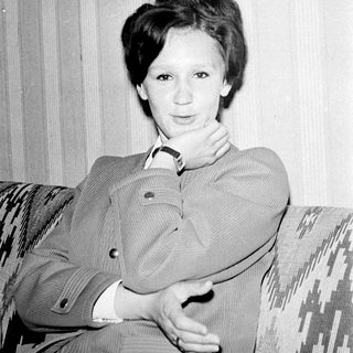Black-and-white portrait of a woman in a blazer.