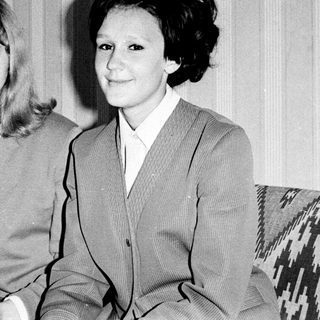 Two women posing together in formal attire, black-and-white.