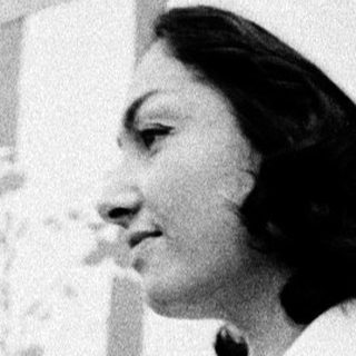 Woman in vintage nurse uniform with floral dress.