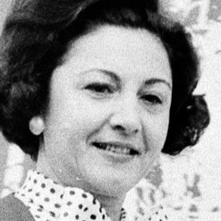 Woman in 1960s-style polka-dot sweater and coat.