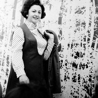 Woman in 1960s-style polka-dot sweater and coat.