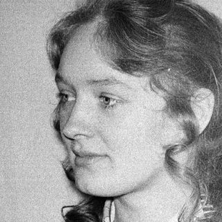 Young woman with shoulder-length hair in a vintage sweater.