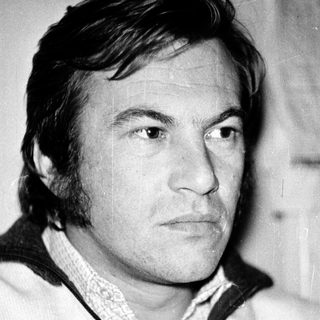 Portrait of a man with short hair in a sweater.