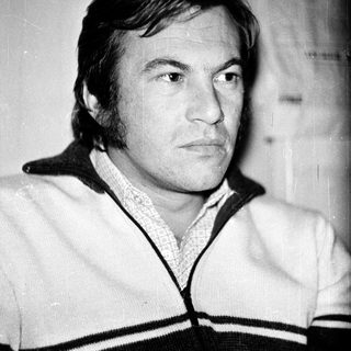 Portrait of a man with short hair in a sweater.