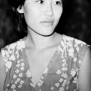 Black-and-white portrait of a young woman with short hair.