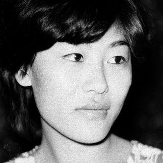 Black-and-white portrait of a young woman with short hair.
