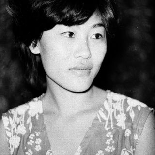 Black-and-white portrait of a young woman with short hair.