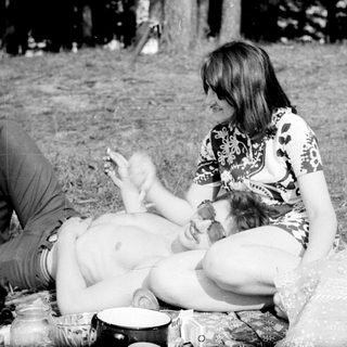 People relaxing outdoors, picnicking at night.