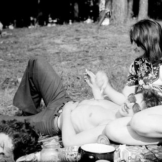 People relaxing outdoors, picnicking at night.