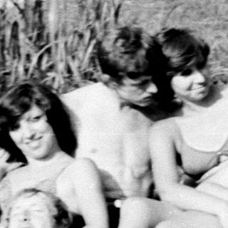 Group of people relaxing outdoors by water.