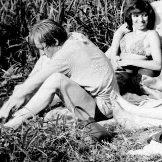 Group enjoying picnic by lake.