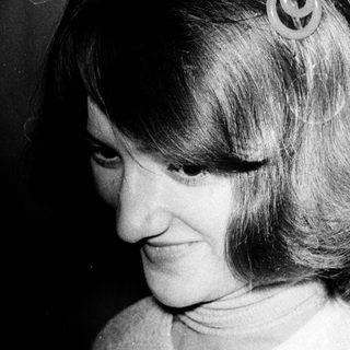 Woman with short hair and side curls.