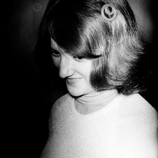 Woman with short hair and side curls.