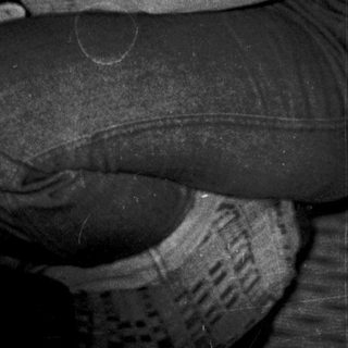 A person sitting indoors in casual clothing.