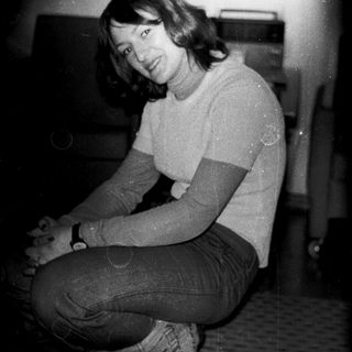 A person sitting indoors in casual clothing.