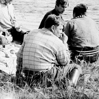 People picnicking by a lake.