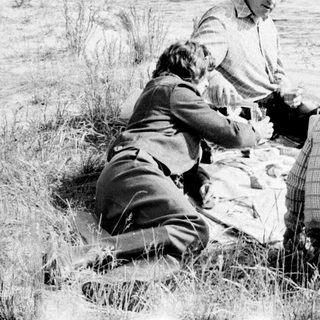 People picnicking by a lake.