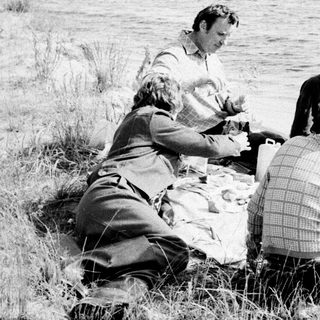 People picnicking by a lake.