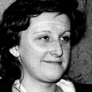 Black-and-white portrait of a woman in mid-20th century attire.