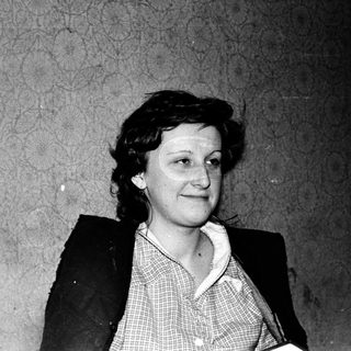Black-and-white portrait of a woman in mid-20th century attire.