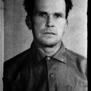 Black-and-white portrait of a man in formal attire.