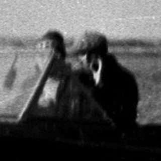 Small boat moving swiftly on rough sea.