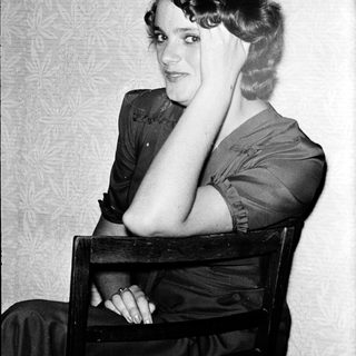 Portrait of a woman in 1920s-30s style clothing.