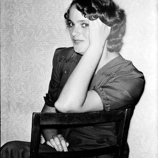 Portrait of a woman in 1920s-30s style clothing.