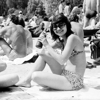Sunbathing and socializing at a beach party.