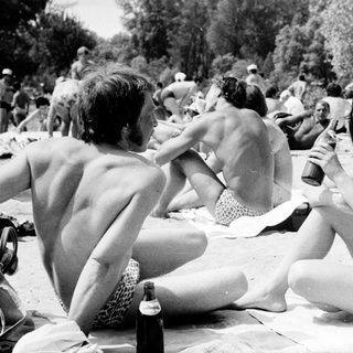 Sunbathing and socializing at a beach party.