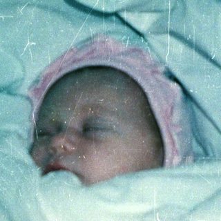 Newborn baby wrapped snugly in a blanket.