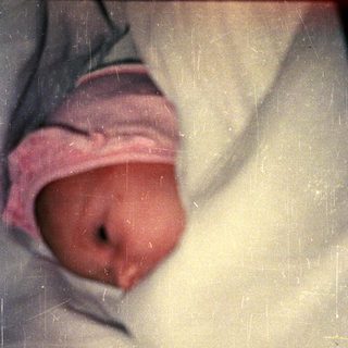 Newborn baby wrapped in a blanket.