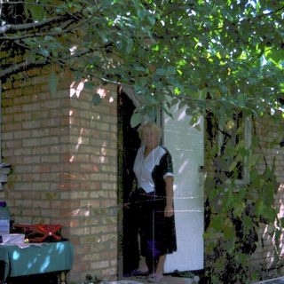 A person standing in doorway with open door.