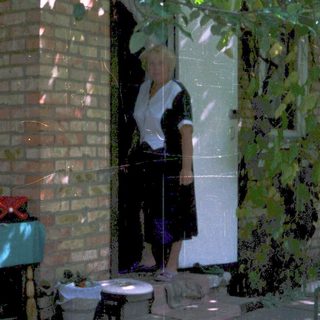 A person standing in doorway with open door.