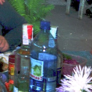 Two people enjoying meal outdoors with drinks.