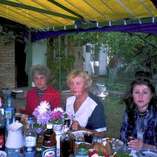 Group of women enjoying outdoor meal together.