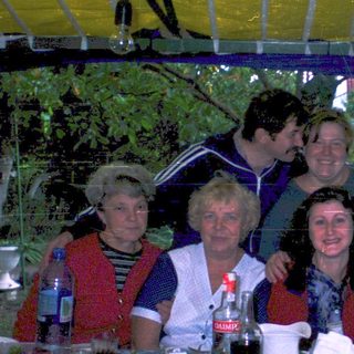 Group gathering outdoors at a festive table.