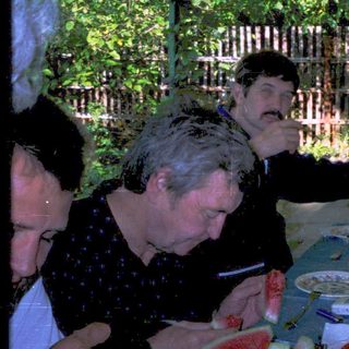 Group enjoying outdoor evening meal together.